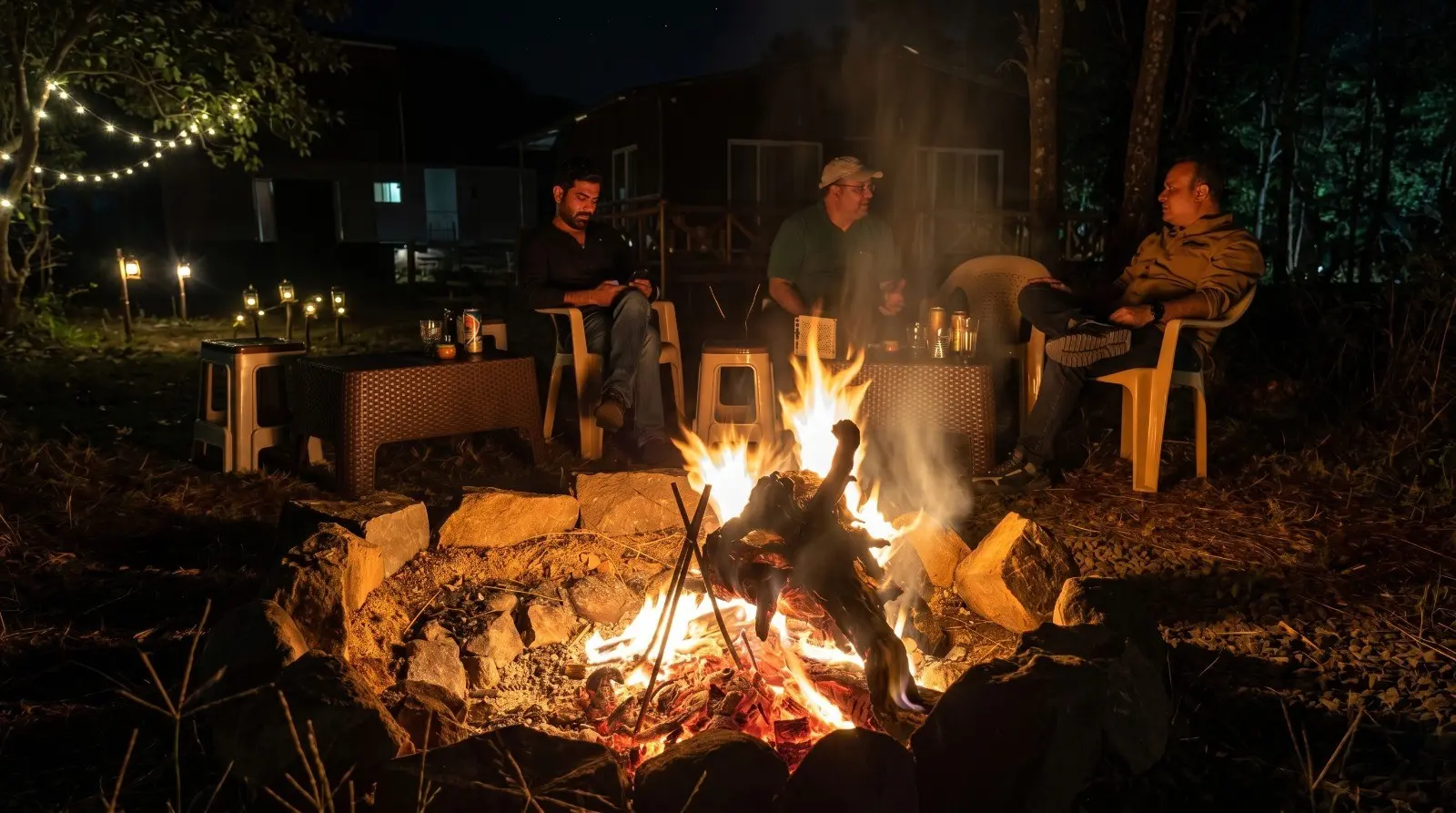 Guests enjoying campfire night at Wildlife Jungle Resort with cozy outdoor seating in forest